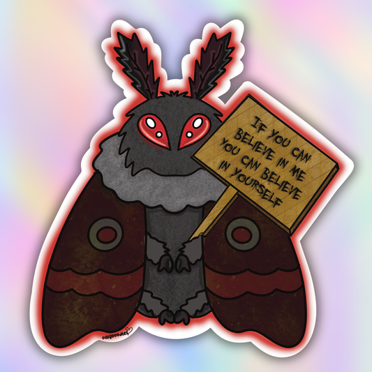 Close-up vinyl sticker of a fuzzy cartoon Mothman with glowing red eyes holding a motivational wooden sign.