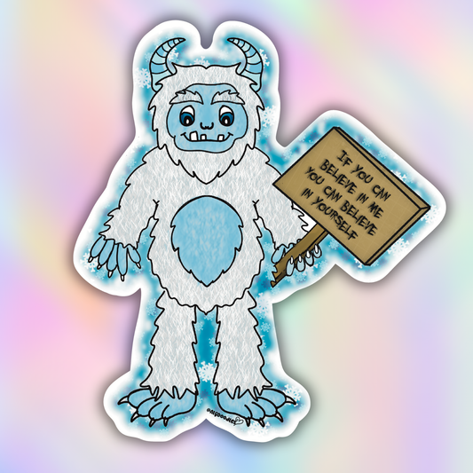 Close-up vinyl sticker of a fluffy blue and white yeti holding a motivational wooden sign that says “If you can believe in me you can believe in yourself.”